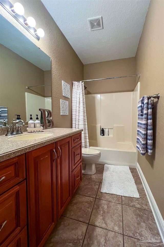 full bathroom with a textured ceiling, tile patterned flooring, toilet, vanity, and visible vents