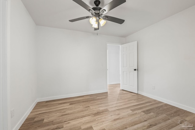 spare room with ceiling fan and light wood-type flooring