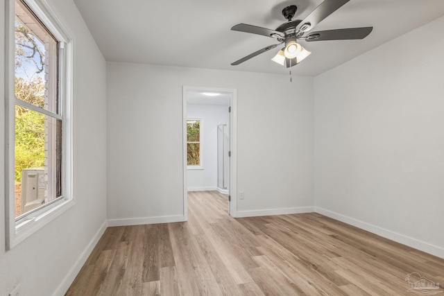 empty room with light hardwood / wood-style flooring and ceiling fan