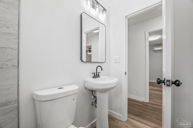 bathroom featuring wood-type flooring and toilet