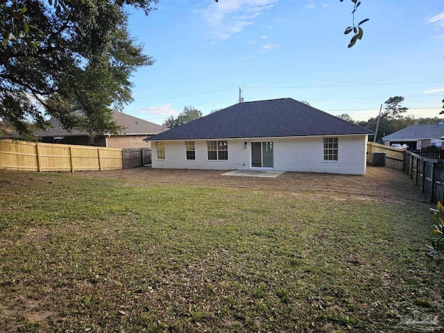 rear view of property featuring central air condition unit, a patio area, and a yard