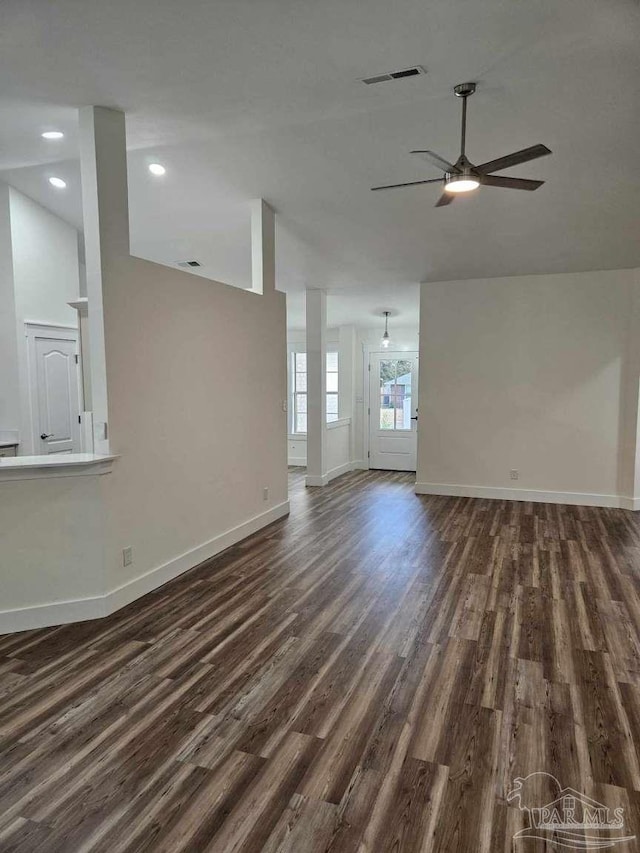 unfurnished living room featuring ceiling fan and dark hardwood / wood-style floors