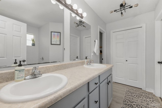 6439 Dallas Ave, Pensacola, FL 32526 - full bath with double vanity, a sink, and wood finished floors