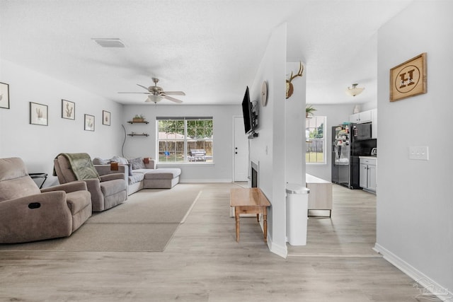 6439 Dallas Ave, Pensacola, FL 32526 - living room with ceiling fan, visible vents, baseboards, and light wood-type flooring