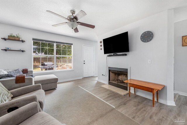 6439 Dallas Ave, Pensacola, FL 32526 - living room featuring a fireplace with flush hearth, baseboards, ceiling fan, and light wood-style flooring
