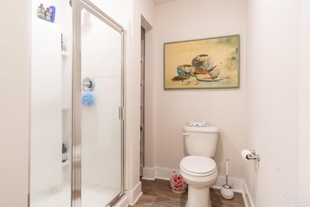 bathroom featuring walk in shower, toilet, and hardwood / wood-style floors