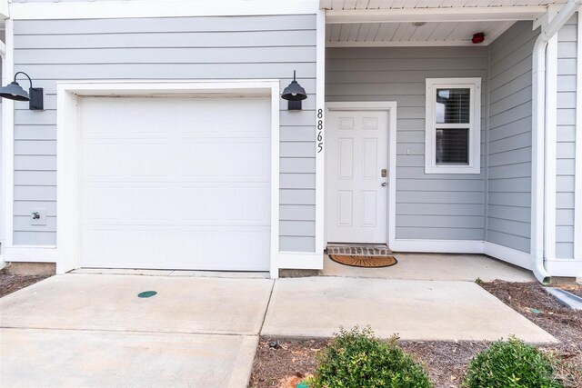 view of exterior entry with a garage