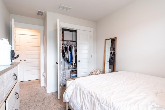 bedroom featuring a closet and light colored carpet