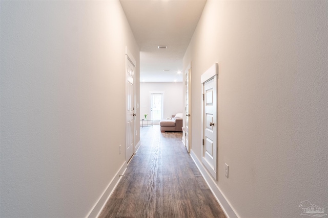 hall with hardwood / wood-style floors