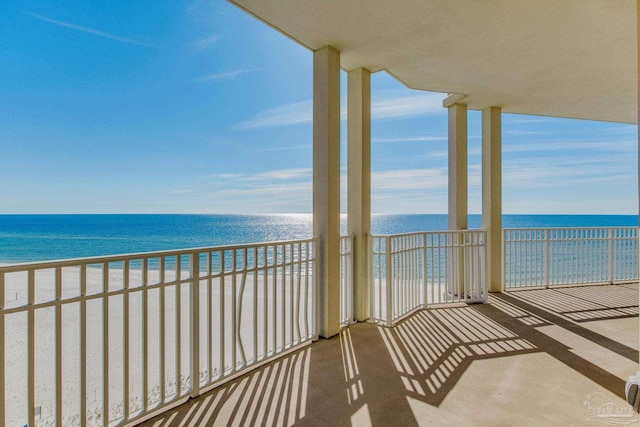 balcony featuring a water view and a view of the beach