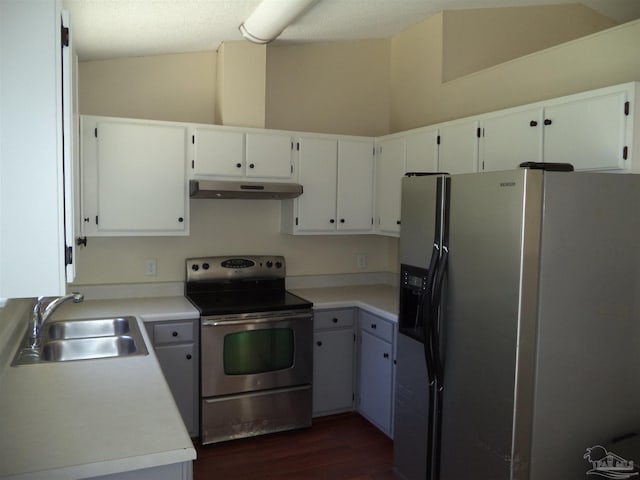 kitchen featuring a textured ceiling, stainless steel appliances, dark wood-type flooring, sink, and white cabinetry