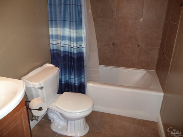 full bathroom with tile patterned flooring, vanity, toilet, and shower / bath combo with shower curtain