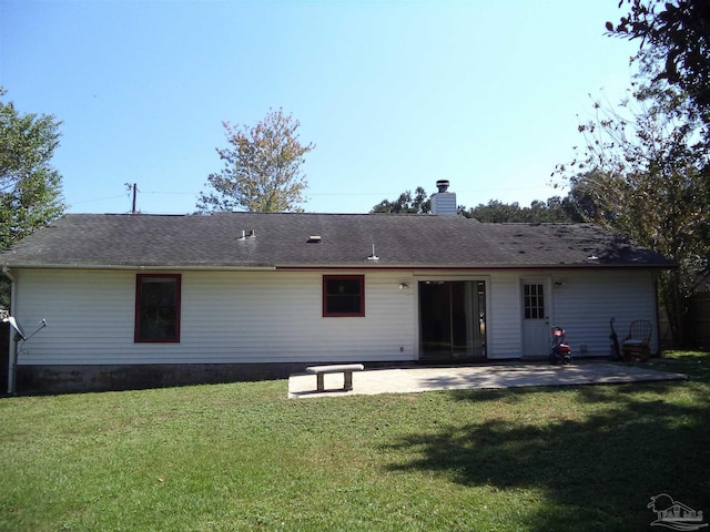 rear view of house featuring a patio and a lawn