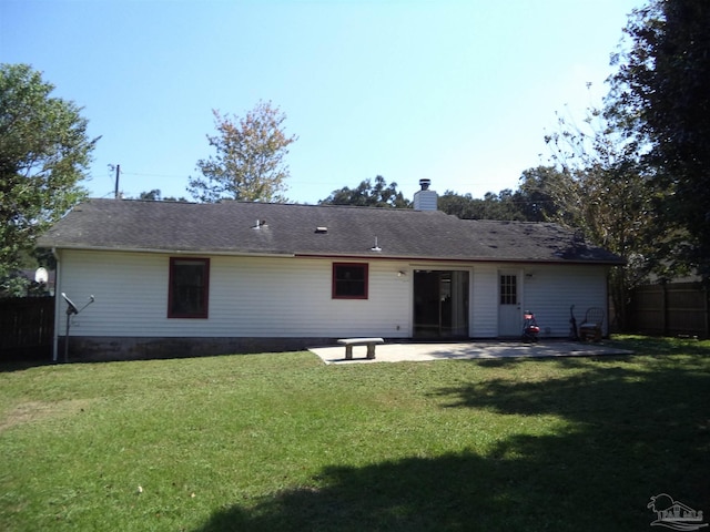 rear view of property with a patio area and a lawn