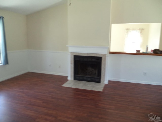 unfurnished living room featuring dark hardwood / wood-style floors and a fireplace