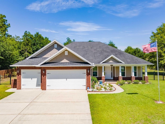 4982 Red Oak Dr, Milton, FL 32583 - craftsman-style house with a porch, brick siding, an attached garage, concrete driveway, and a shingled roof