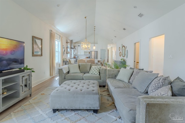 920 W Chase St, Pensacola, FL 32502 - living room with high vaulted ceiling, a chandelier, and light hardwood / wood-style floors