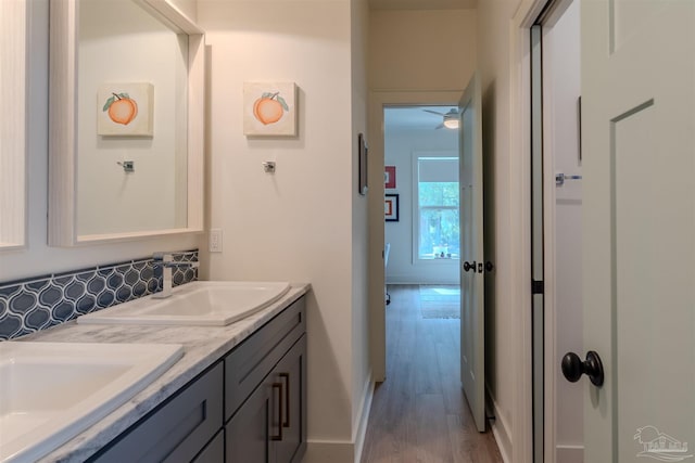 920 W Chase St, Pensacola, FL 32502 - bathroom with vanity, hardwood / wood-style floors, and tasteful backsplash