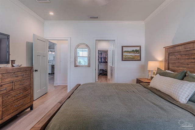 920 W Chase St, Pensacola, FL 32502 - bedroom with a walk in closet, ornamental molding, and light hardwood / wood-style floors