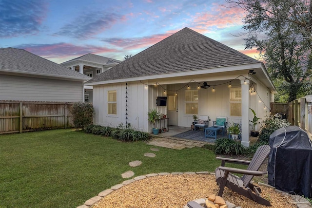 920 W Chase St, Pensacola, FL 32502 - back house at dusk featuring ceiling fan, a yard, and a patio