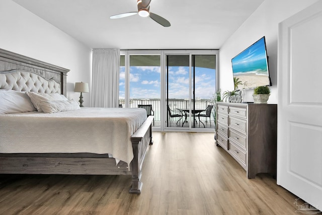 bedroom featuring light wood-type flooring, access to outside, floor to ceiling windows, and ceiling fan