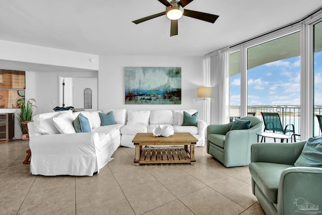 living room featuring a ceiling fan, wine cooler, floor to ceiling windows, and light tile patterned floors