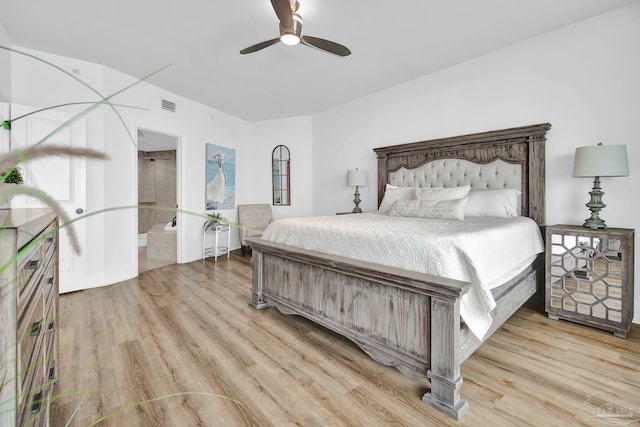 bedroom with light wood finished floors, ceiling fan, visible vents, and connected bathroom