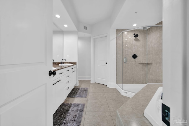 bathroom with vanity, a shower stall, visible vents, and tile patterned floors