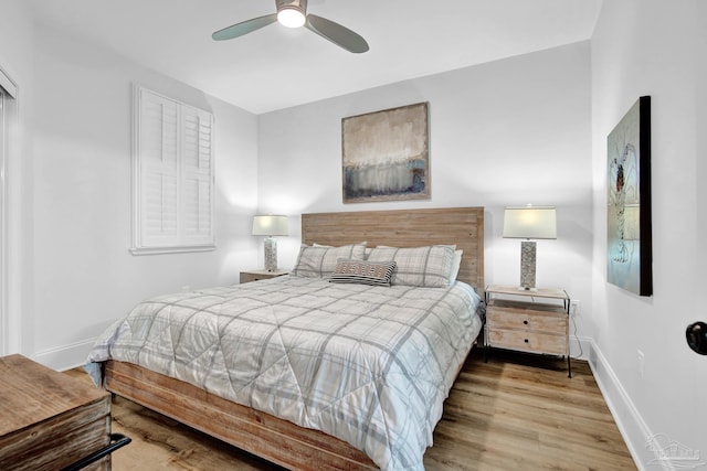 bedroom featuring wood finished floors, a ceiling fan, and baseboards