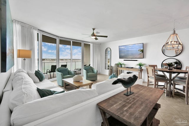 living room with light tile patterned floors, expansive windows, and a ceiling fan