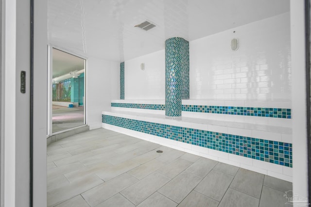 interior space with wood tiled floor and visible vents