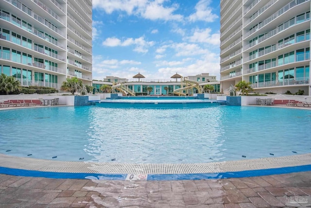 view of pool with a water slide