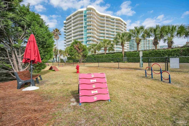 view of home's community featuring a lawn and fence