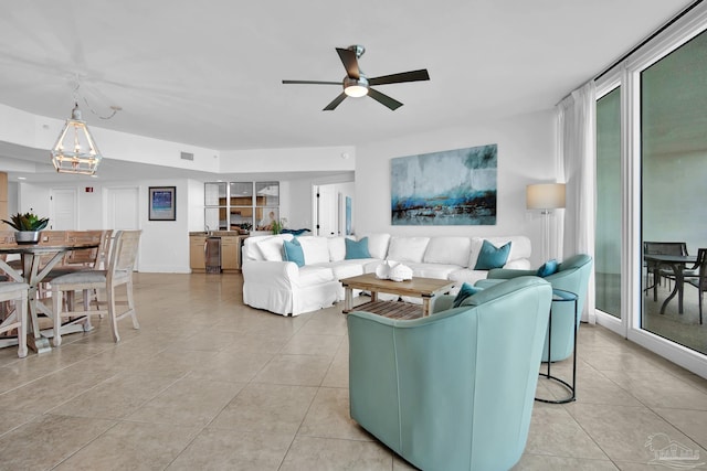 living area with ceiling fan, visible vents, and light tile patterned flooring