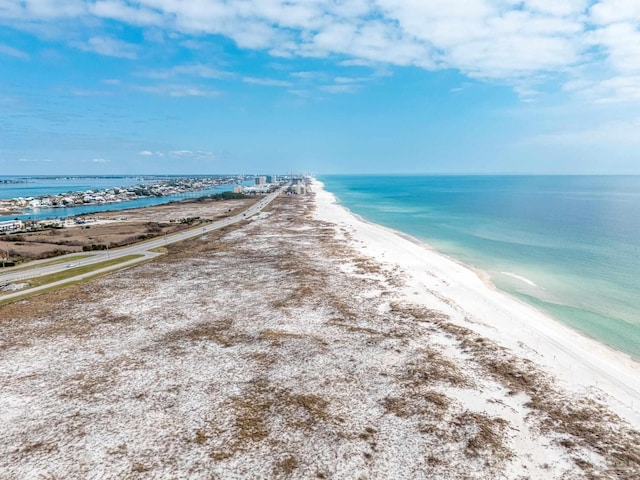 drone / aerial view featuring a water view and a beach view