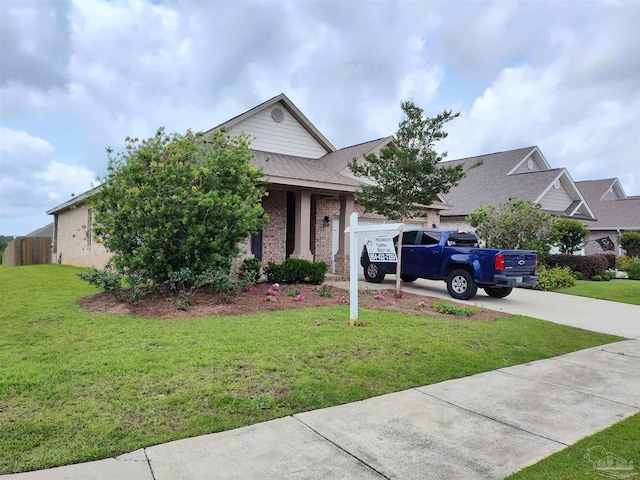 view of property hidden behind natural elements with a front yard