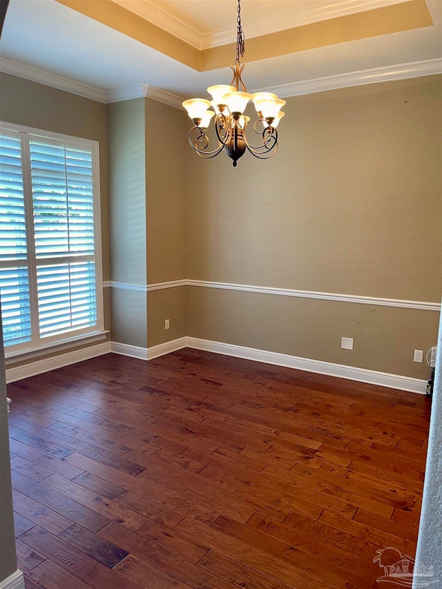 unfurnished room with an inviting chandelier, crown molding, and dark hardwood / wood-style flooring