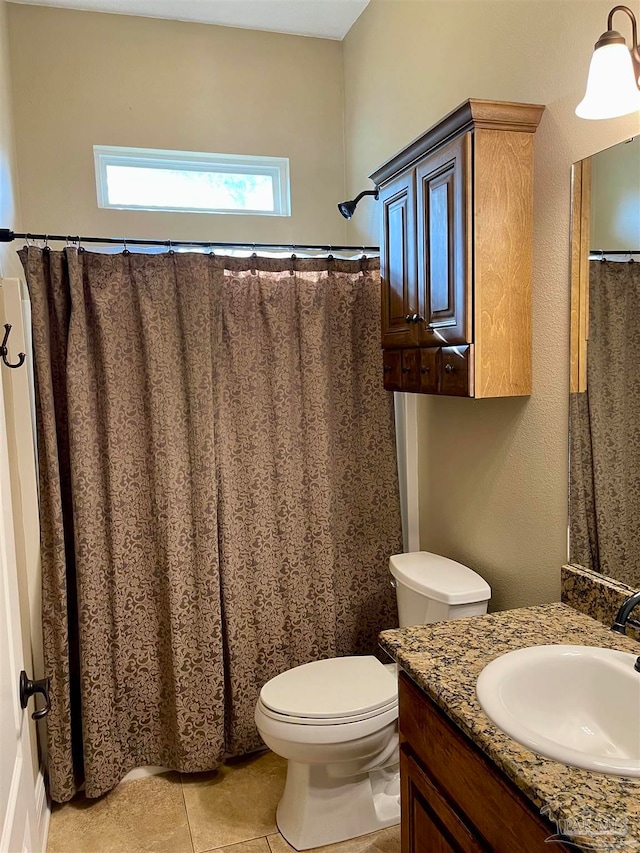 bathroom featuring vanity, curtained shower, toilet, and tile patterned flooring