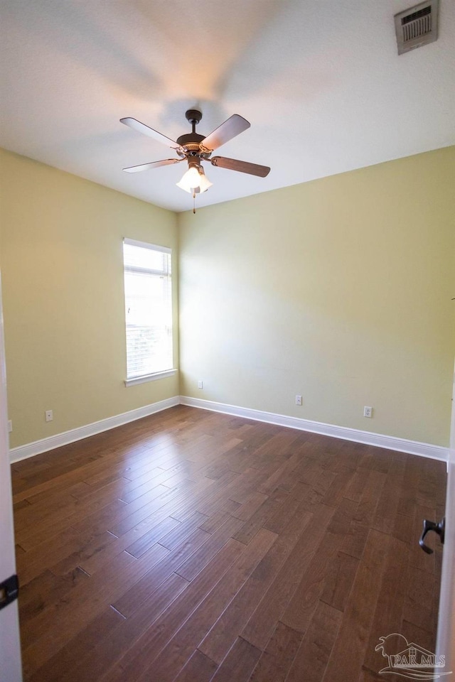 empty room with ceiling fan and dark hardwood / wood-style floors