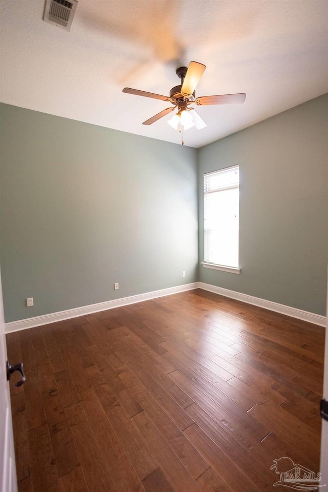 spare room featuring ceiling fan and dark hardwood / wood-style flooring