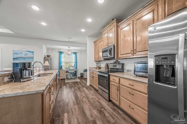 kitchen with light stone counters, dark wood-style flooring, a sink, stainless steel appliances, and a toaster