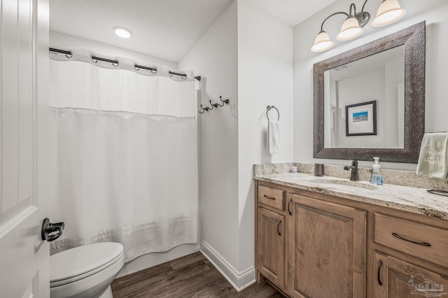 full bathroom featuring shower / tub combo, vanity, baseboards, toilet, and wood finished floors