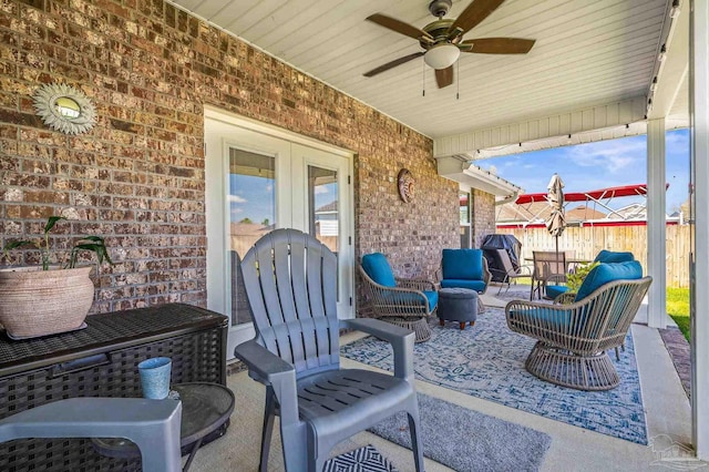 view of patio / terrace with fence, a ceiling fan, and an outdoor hangout area