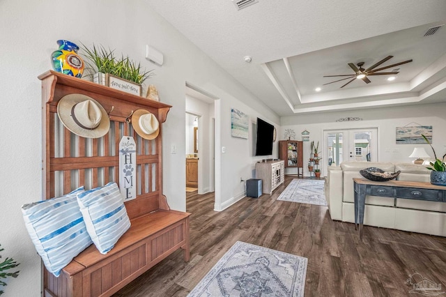 living room featuring baseboards, a raised ceiling, a ceiling fan, wood finished floors, and french doors