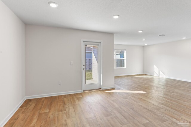 unfurnished room featuring light wood-style floors, baseboards, and recessed lighting