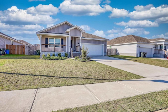 ranch-style home featuring a porch, fence, a garage, driveway, and a front lawn