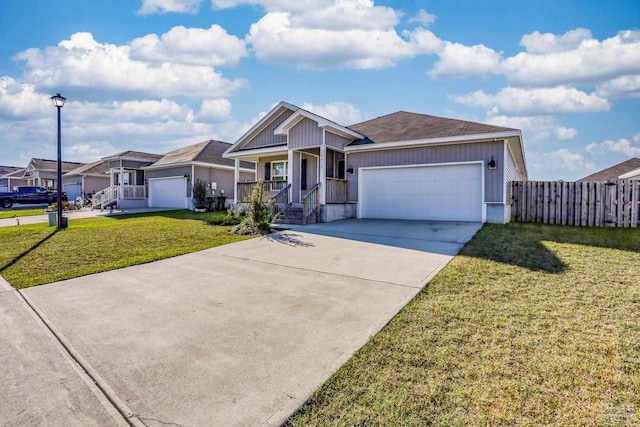 view of front of house featuring an attached garage, covered porch, fence, concrete driveway, and a front lawn