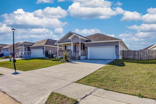 ranch-style house featuring driveway, a porch, an attached garage, and a front yard