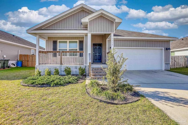 ranch-style house with a garage, driveway, covered porch, and fence