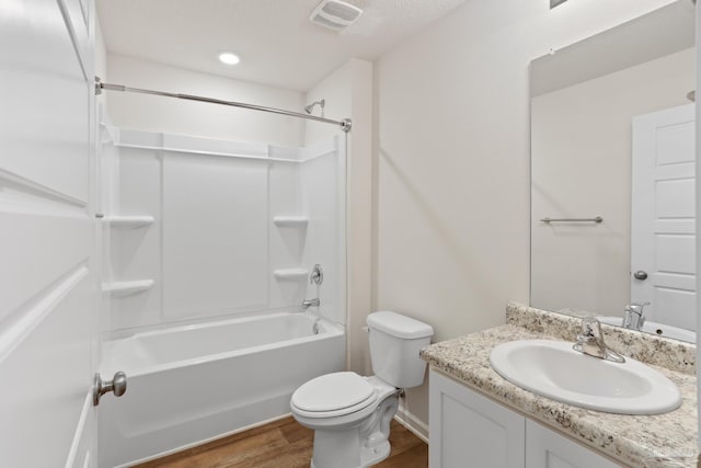 full bathroom featuring visible vents, toilet, shower / tub combination, wood finished floors, and vanity